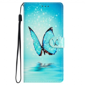 Etui Folio do iPhone 15 z Łańcuch Niebieski Motyl W Locie Z Paskiem